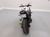a motorcycle parked in a room with a number plate on the back of it