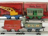 three toy trains on a train track with a crane