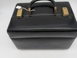 black leather briefcase with brass handles on a white surface