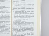 an open book with french text on a gray background