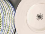 many plates and bowls on the table together