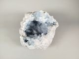 an image of a piece of rock with a small piece of ice on it