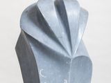 a blue sculpture of a shell on a white pedestal
