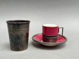 a cup and saucer sitting next to each other on a table