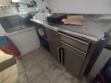 an image of a kitchen with stainless steel counter tops