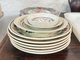 a stack of plates and bowls on a wooden table