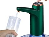 a person pouring water into a glass from a green faucet