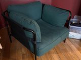 a green chair in the corner of a room