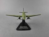 a green model of a plane on a black stand