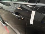 a black car with a sticker on the side of it