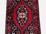 a red and blue rug on a white background
