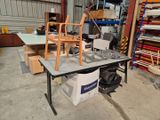 une table sur laquelle est posée une chaise, dans un entrepôt
