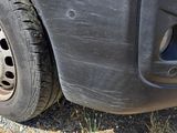 a close up of a car ' s tire on a gravel road