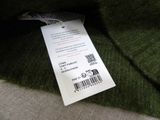 a label on the back of a green sweater