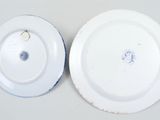 two white plates with blue and white designs on them sitting on a table