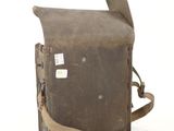 an old camera bag with a strap on it sitting on a white surface