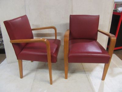 two red chairs sitting next to each other on the floor
