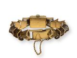 a close up of a bracelet with a chain on a white background