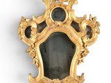 a gold frame with a mirror in it on the wall