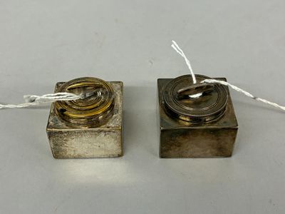 pair of antique silver plated candles with wire wrapped around them