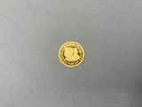 a close up of a gold coin on a gray surface