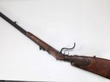 a rifle that is on display on a table