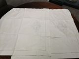a white table cloth with a design on it on a wooden table