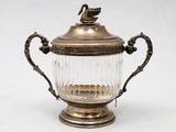 an antique silver plated glass vase with a bird on top