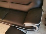 a black and white couch and ottoman in a living room
