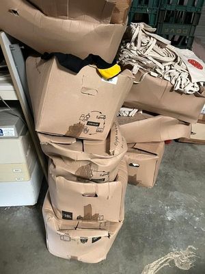 pile of cardboard boxes stacked on top of each other in a warehouse