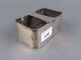 an image of a silver container on a table with a label on it