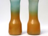 two vases sitting side by side on a white surface