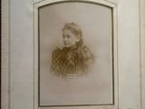 an old photo of a little girl in a dress