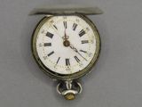 a silver pocket watch with roman numerals on the face