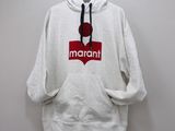 the hoodie is hanging on a hanger on the wall
