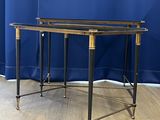 pair of brass and glass side tables on casteors in the style of maison