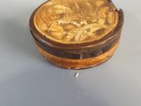 a small wooden box with a gold design on it