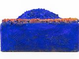 a close up of a blue box with a mountain in the background