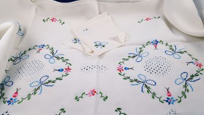 a white dress with blue and pink flowers on it
