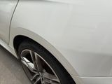 a white car parked on the side of the road