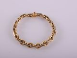 a gold bracelet with a chain link on a white background