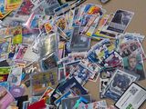 a pile of comic cards on a table next to a pair of scissors