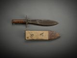 pair of knifes on a gray surface with a black background