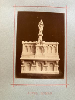 an old photo of a statue of a man on top of a building