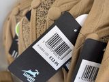 a pair of gloves with a price tag on them