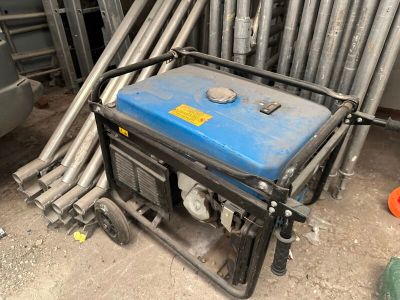 a blue and black generator sitting on the ground
