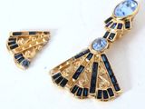 an image of a pair of earrings and a broochle on a table