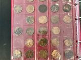 a lot of coins that are in a binder
