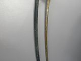 two old swords are displayed on a white surface