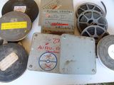 de nombreuses bobines de films anciens et d'autres objets posés sur une table